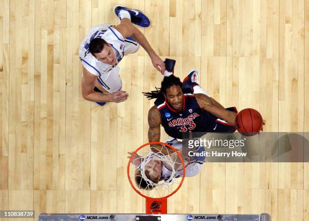 Jesse Perry of the Arizona Wildcats goes to the basket against Miles Plumlee and Kyle Singler of the Duke Blue Devils during the west regional...