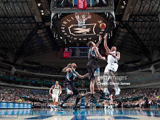Shawn Marion of the Dallas Mavericks shoots against Michael Beasley of the Minnesota Timberwolves on March 24, 2011 at the American Airlines Center...