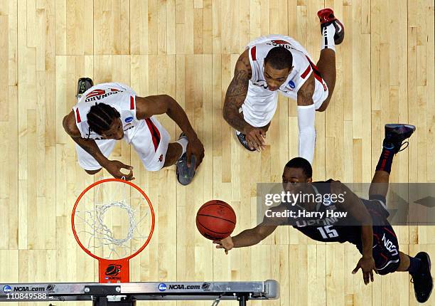 Kemba Walker of the Connecticut Huskies goes to the hoop against Kawhi Leonard and Malcolm Thomas of the San Diego State Aztecs during the west...