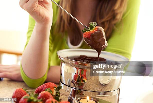 strawberry dipped into melted dark chocolate - chokladfondue bildbanksfoton och bilder