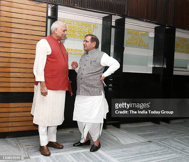 Leader Yashwant Sinha and Janata Dal President Sharad Yadav talk to each other after JPC meeting in New Delhi on Thursday, March 24 2011.