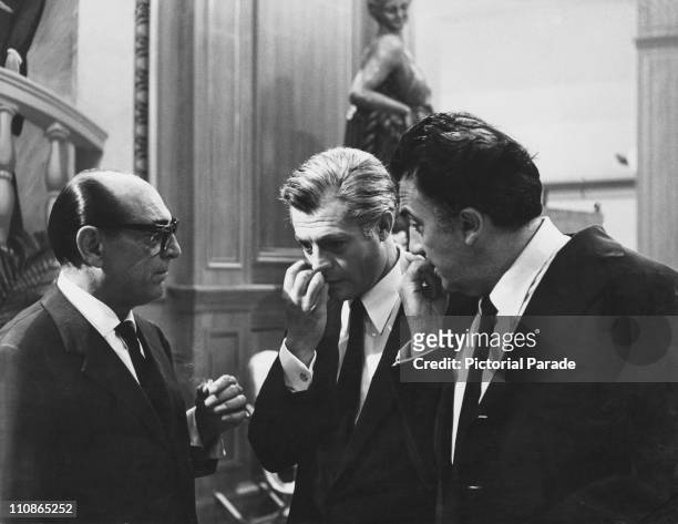 Italian actors Mino Doro and Marcello Mastroianni with director Federico Fellini on the set of '8 1/2', 1963.