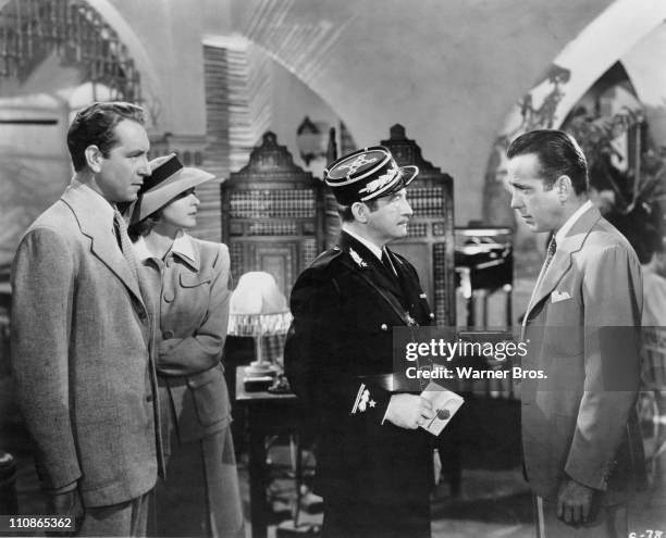 Rick Blaine, played by Humphrey Bogart holds Captain Louis Renault, played by Claude Rains at gunpoint in a scene from 'Casablanca', directed by...