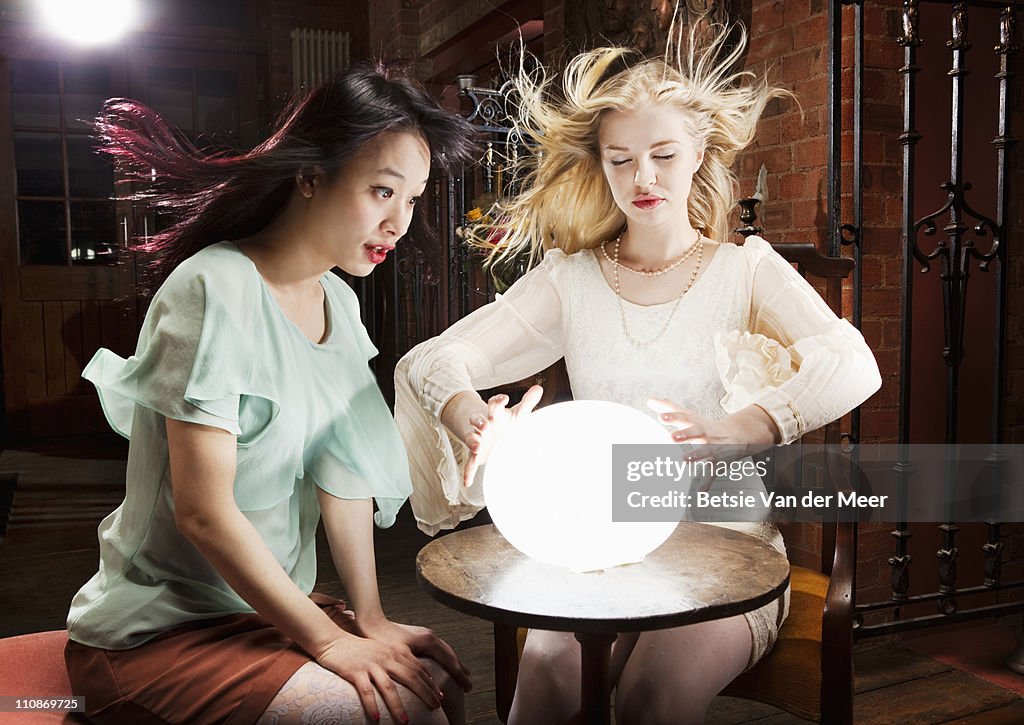 Woman and fortuneteller with crystal ball.