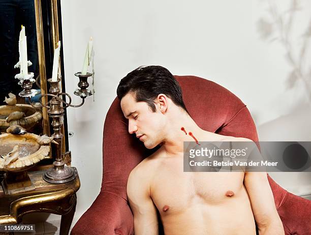 dead man with vampire bite in his neck. - chaise longue stockfoto's en -beelden