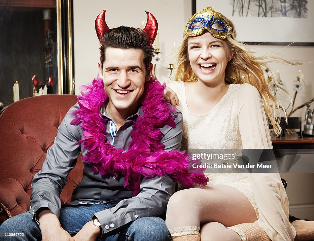 Couple dressed up, laughing.
