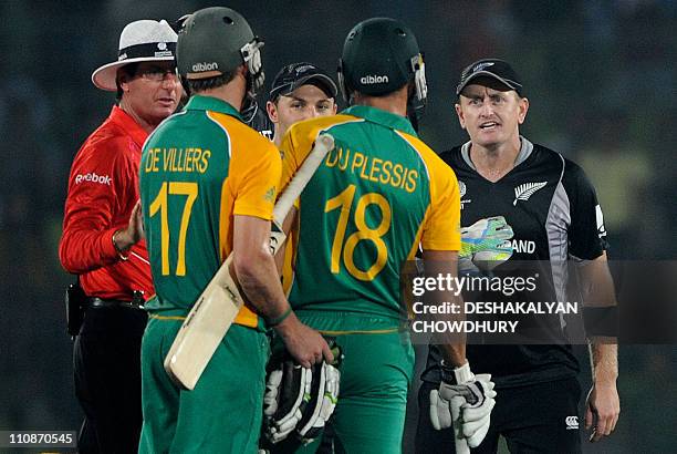 New Zealand cricketer Scott Styris exchanges words with South Africa batsmen Faf du Plessis and AB de Villiers during the quarter-final match of the...