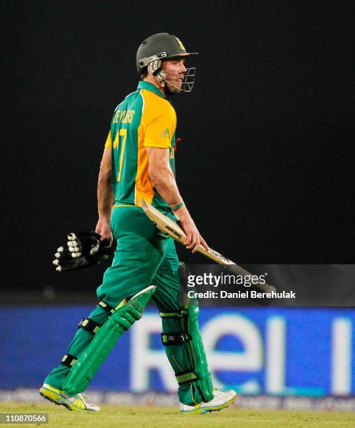 De Villiers of South Africa walks back to the pavillion after having been run out by Martin Guptill of New Zealand during the 2011 ICC World Cup...