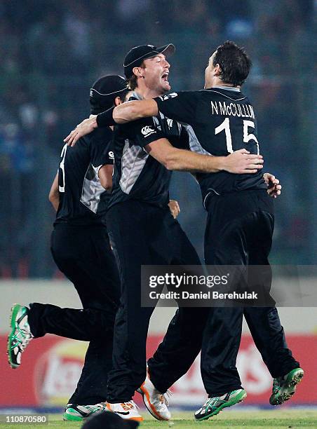 Martin Guptill of New Zealand celebrates with team mate Nathan McCullum after running out AB de Villiers of South Africa during the 2011 ICC World...