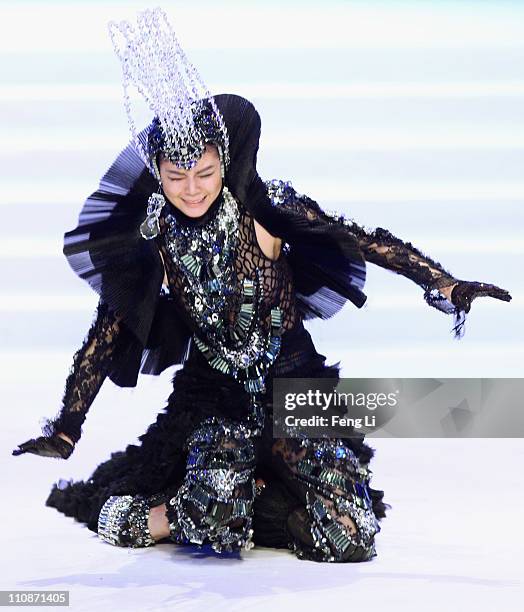 Model falls while presenting a creation for Beijing Institute of Fashion Technology and Taiwan Shin Chien University Graduates Collection during...