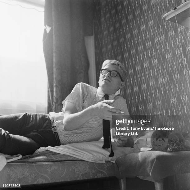 English artist David Hockney reclining on a bed, 1963.