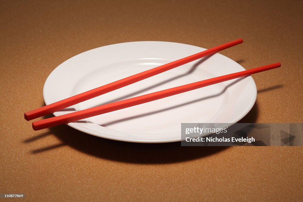 Small empty plate with chopsticks