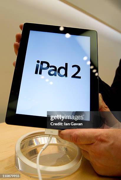 Person holds the new Apple iPad 2 as it goes on sale at Apple Store, Regent Street on March 25, 2011 in London, England. The latest iPad went on sale...