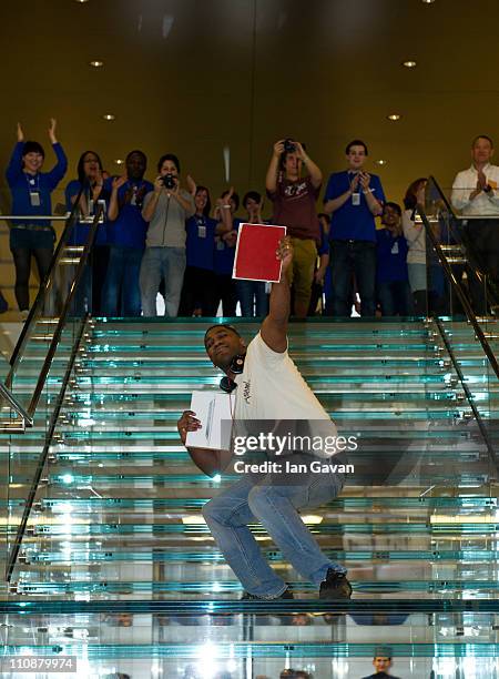 Jewels Lewis poses as the first customer to purchase the new Apple iPad 2 at Apple Store, Regent Street on March 25, 2011 in London, England. The...