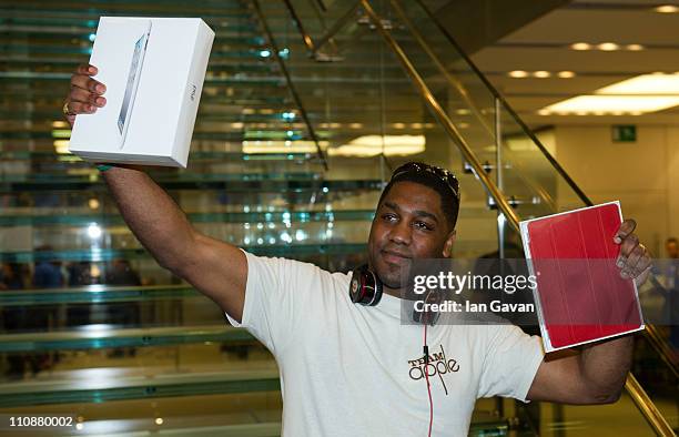 Jewels Lewis poses as the first customer to purchase the new Apple iPad 2 at Apple Store, Regent Street on March 25, 2011 in London, England. The...