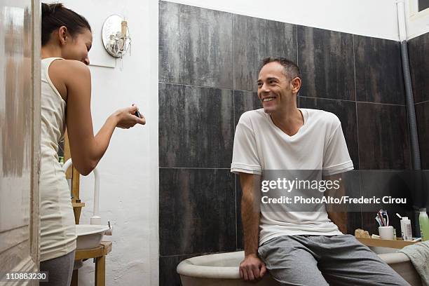 couple talking and laughing in bathroom - bad relationship stock-fotos und bilder