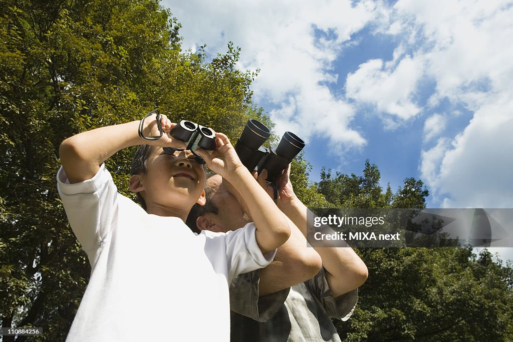 Father and Son Looking Through Binoculars