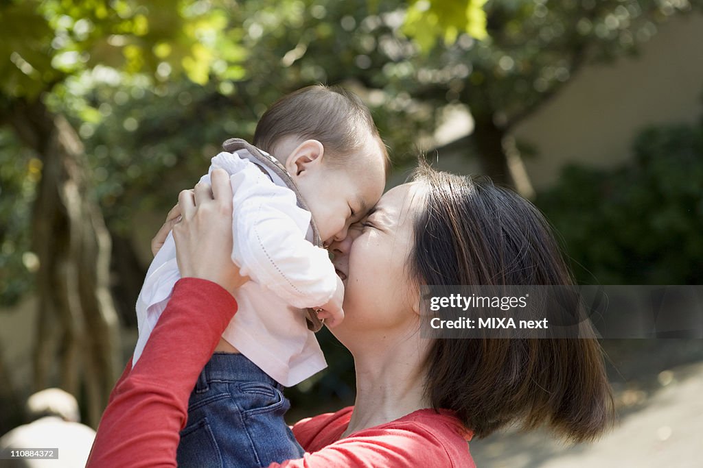 Mother Kissing Baby Girl
