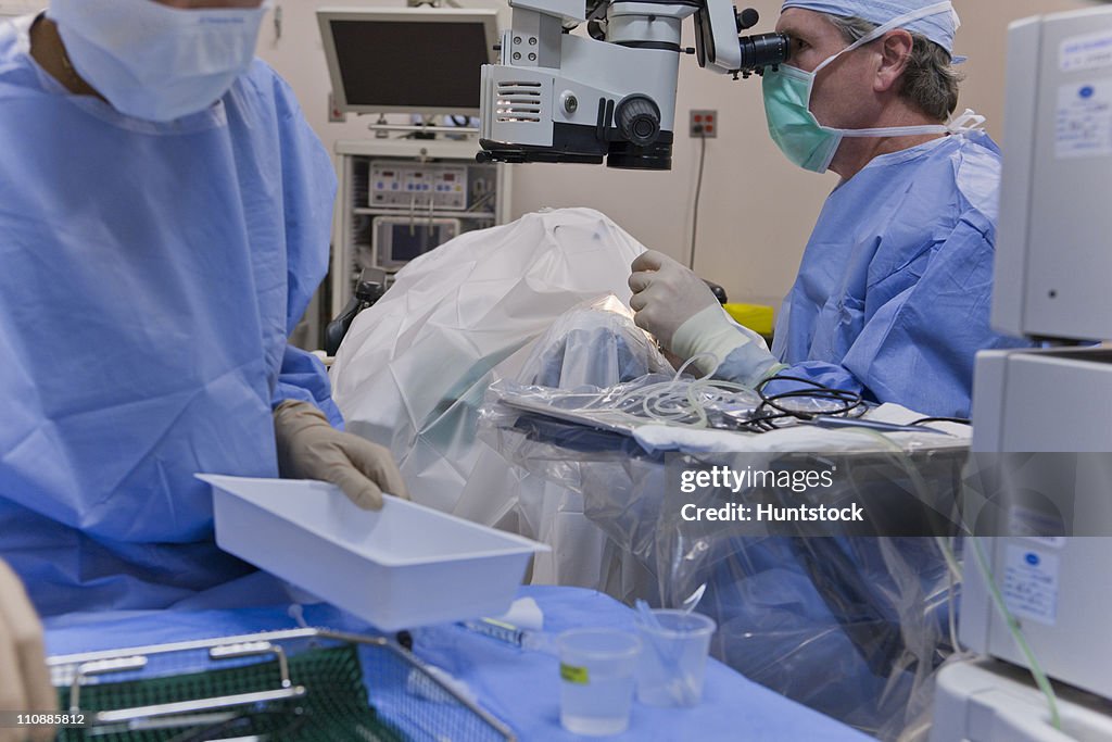 Surgical technologist cleaning up back table