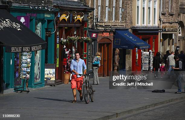 Man walks past souvenir shops on the Royal Mile in the heart of the historic old town on March 25, 2011 in Edinburgh, Scotland.The cities Old and New...