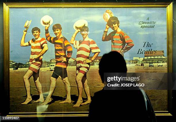 Visitor looks at a signed poster of the British band The Beatles at the Rock Museum in Barcelona on March 25, 2011. The museum, a new addition to the...