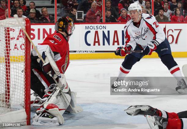 Craig Anderson the Ottawa Senators makes a save as Alexander Semin of the Washington Capitals swings his stick at the rebound at Scotiabank Place on...