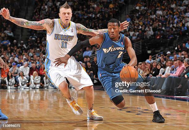 John Wall of the Washington Wizards drives to the basket against Chris Andersen of the Denver Nuggets on March 25, 2011 at the Pepsi Center in...