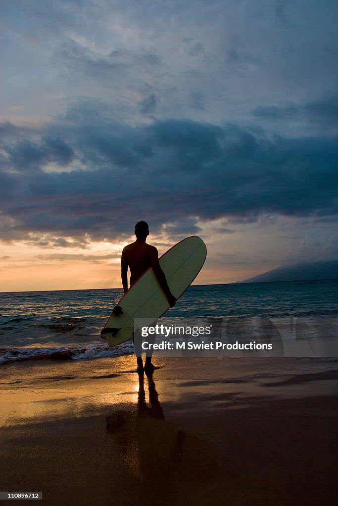 Surfer silhouette sunset, Hawaii