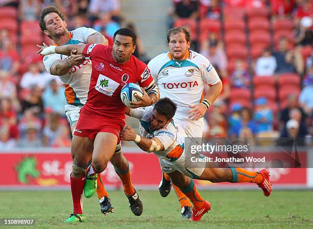 Digby Ioane of the Reds breaks through the Cheetahs defense during the round six Super Rugby match between the Reds and the Cheetahs at Suncorp...