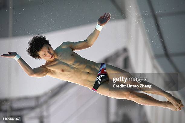 Qiu Bo of China competes in the Men's 10m Platform semi- final during the FINA Diving World Series at the Beijing National Aquatics Center on March...