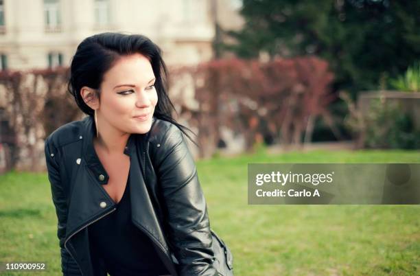 woman on grass - chaqueta de piel imágenes fotografías e imágenes de stock