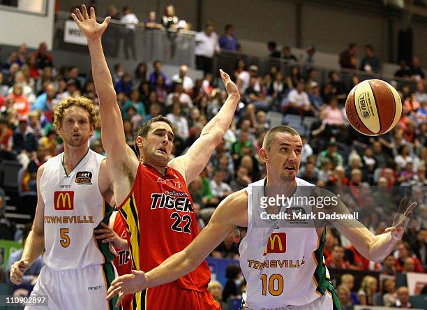 Russell Hinder of the Crocodiles gathers a loose ball during the round 24 NBL match between the Melbourne Tigers and the Townsville Crocodiles at...