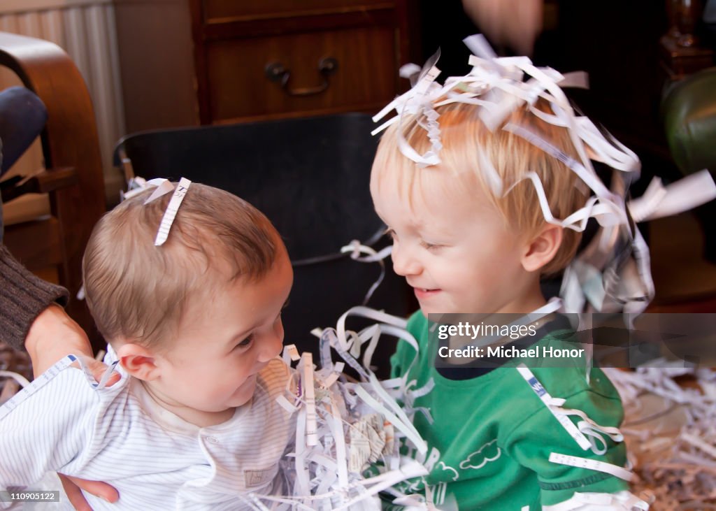 Boys playing with shredded paper