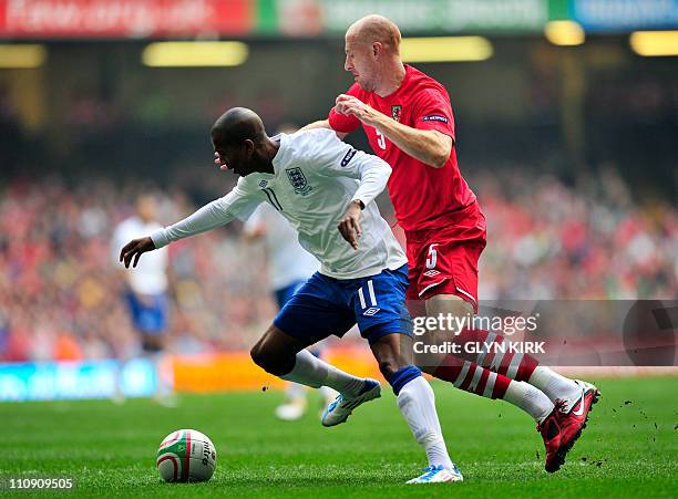England's midfielder Ashley Young is brought down by Wales' defender James Collins , resulting in a penalty during their Euro 2012, group G...