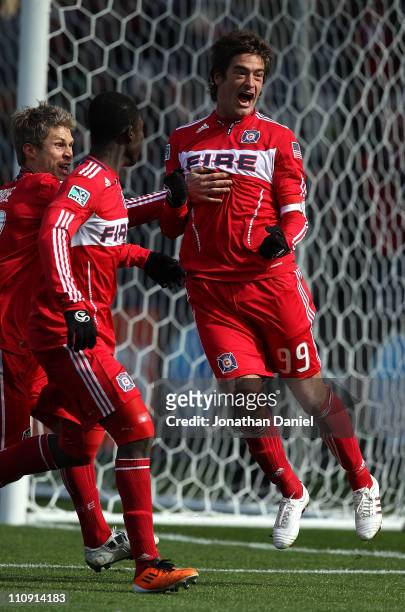 Diego Chaves of the Chicago Fire celebrates a penalty kick goal with teammates Logan Pause and Patrick Nyarko against Sporting Kansas City during an...