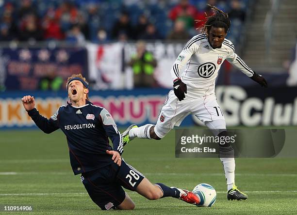 Joseph Ngwenya of DC United trips up Pat Phelan of the New England Revolution on March 26, 2011 at Gillette Stadium in Foxboro, Massachusetts.