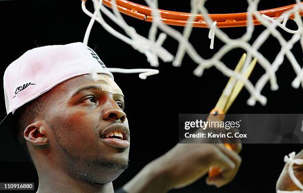 Shelvin Mack of the Butler Bulldogs celebrates defeating the Florida Gators 74 to 71 in overtime by cuttin down part of the ner during the Southeast...