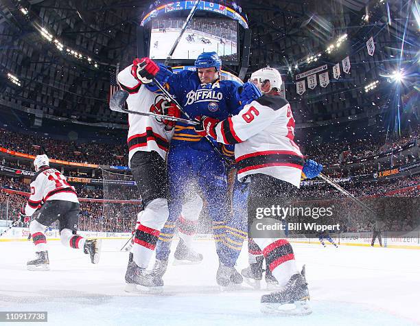 Paul Gaustad of the Buffalo Sabres charges to the net trying to squeeze between Andy Greene and David Steckel of the New Jersey Devils at HSBC Arena...