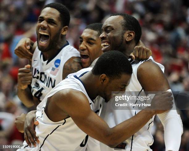 Kemba Walker, Donnell Beverly, Roscoe Smith and Alex Oriakhi of the Connecticut Huskies celebrate after defeating the Arizona Wildcats during the...