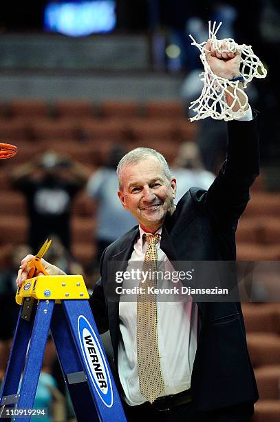 Head coach Jim Calhoun of the Connecticut Huskies cuts down the net after defeatng the Arizona Wildcats to win the west regional final of the 2011...