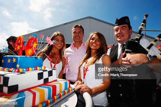 Former F1 driver and BBC commentator David Coulthard receives a cake to celebrate his 40th birthday before the Australian Formula One Grand Prix at...