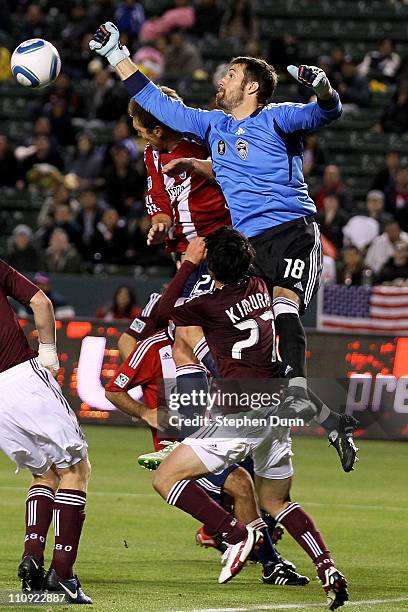 Goal keeper Matt Pickens of the Colorado Rapids jumps to bat the ball away from Jimmy Conrad of Chivas USA in front of Rapids defender Kosuke Kimura...