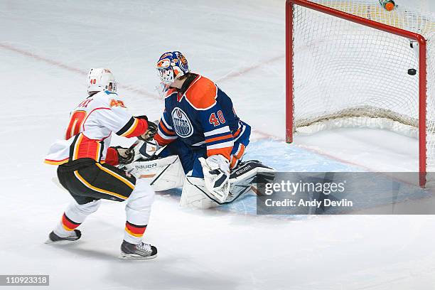 Alex Tanguay of the Calgary Flames scores on his shoot-out attempt on Devan Dubnyk of the Edmonton Oilers at Rexall Place on March 26, 2011 in...