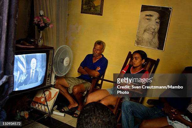 The Calderon family at their home in The Centro Havana neighborhood watches a live televised address by former President Jimmy Carter who speaks in...