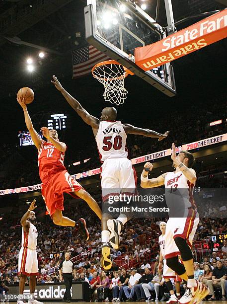 Forward Mike Miller and Joel Anthony of the Miami Heat defend against gurad Kevin Martin of the Houston Rockets at American Airlines Arena on March...