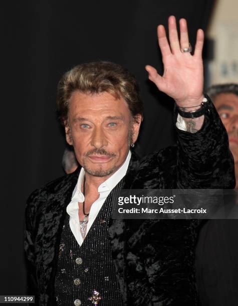 Johnny Hallyday waves to his fans during his new album launch celebration at the Virgin Megastore Champs-Elysees on March 27, 2011 in Paris, France.