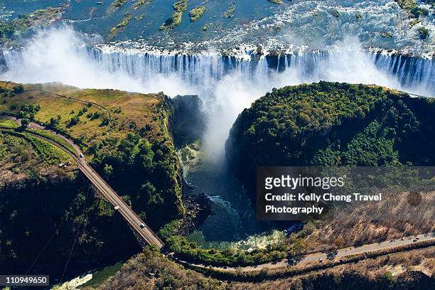 view of victoria falls and bridge - zimbabwe stock pictures, royalty-free photos & images