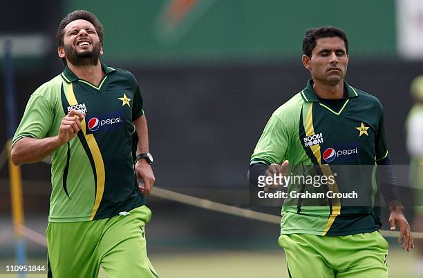 Shahid Afridi and Abdul Razzak do sprint training during a Pakistan nets session at the Punjab Cricket Association Stadium on March 28, 2011 in...