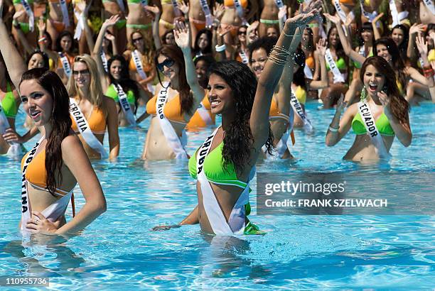 Maria Silvana Belli, Miss Argentina 2008, and Tracey Nicolaas, Miss Aruba 2008, wave to the cameras poolside at Diamond Bay Resort and Golf in their...