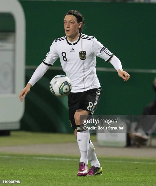 Mesut Oezil of Germany controls the ball during the EURO 2012 Group A qualifier match between Germany and Kazakhstan at Fritz-Walter-Stadium on March...